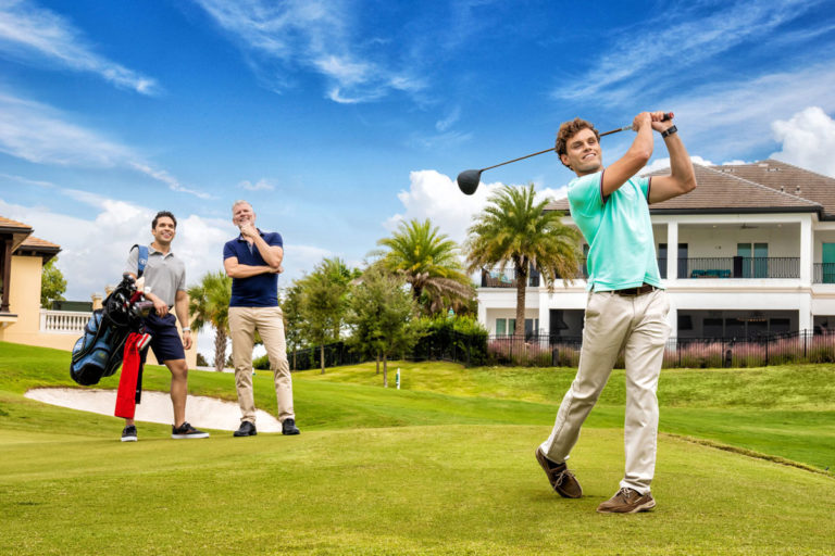 People playing golf on a course at The Bear’s Den Resort Orlando, a Florida luxury vacation home realty resort.