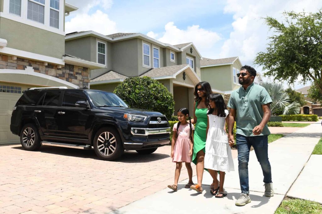 Family with young children walking outside a row of Encore Resort homes